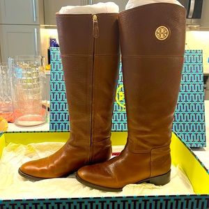 Brown Tory Burch tall riding boots.